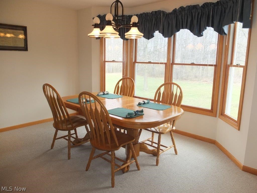 7327 Navarre Road Southwest Massillon, OH 44646 - Photo 3 of 26 Dining room has bay window and is open to the great room and kitchen.