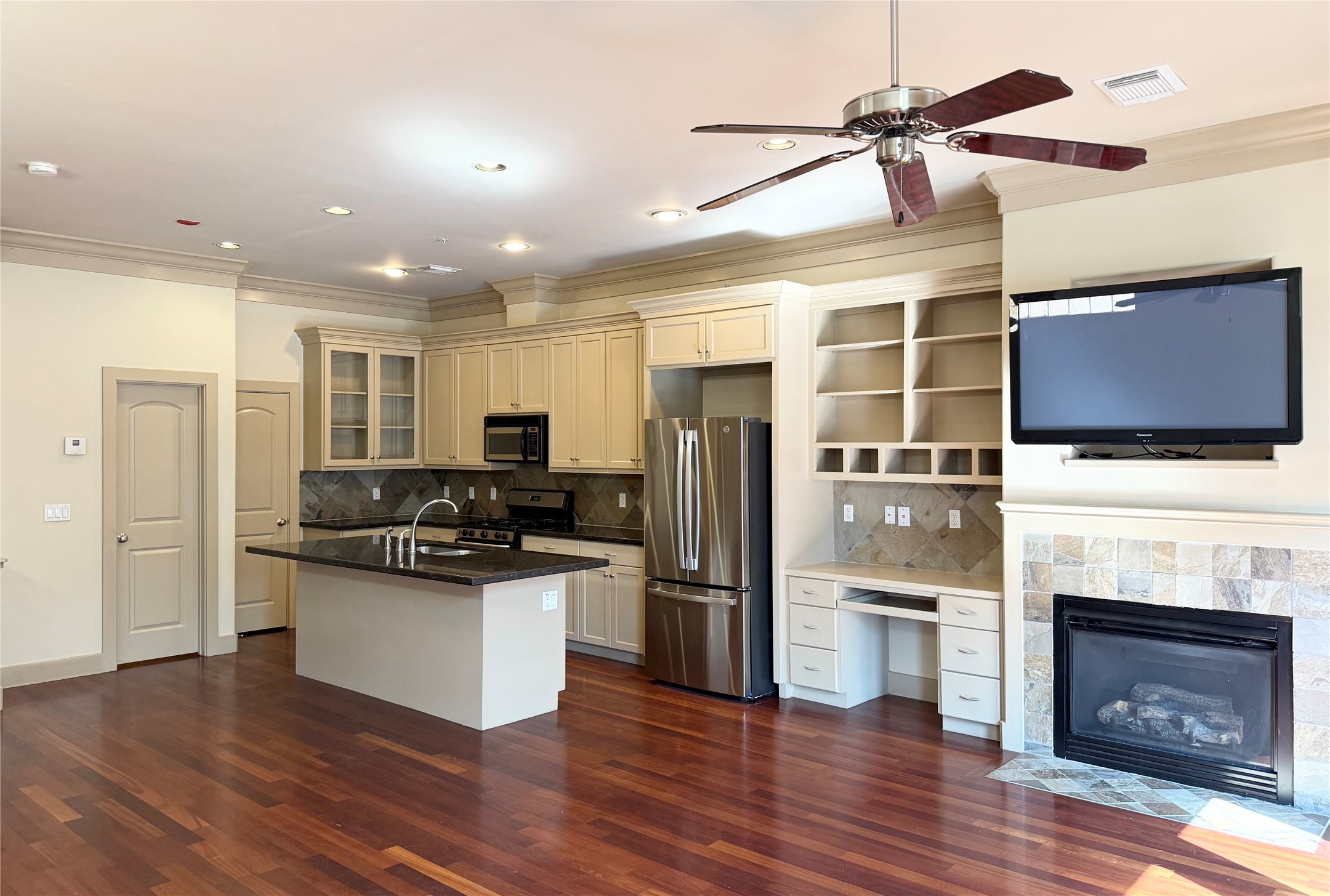 953 Yale Street, Unit 1 Houston, TX 77008 - Photo 9 of 24 a kitchen with stainless steel appliances kitchen island granite countertop a stove and a refrigerator