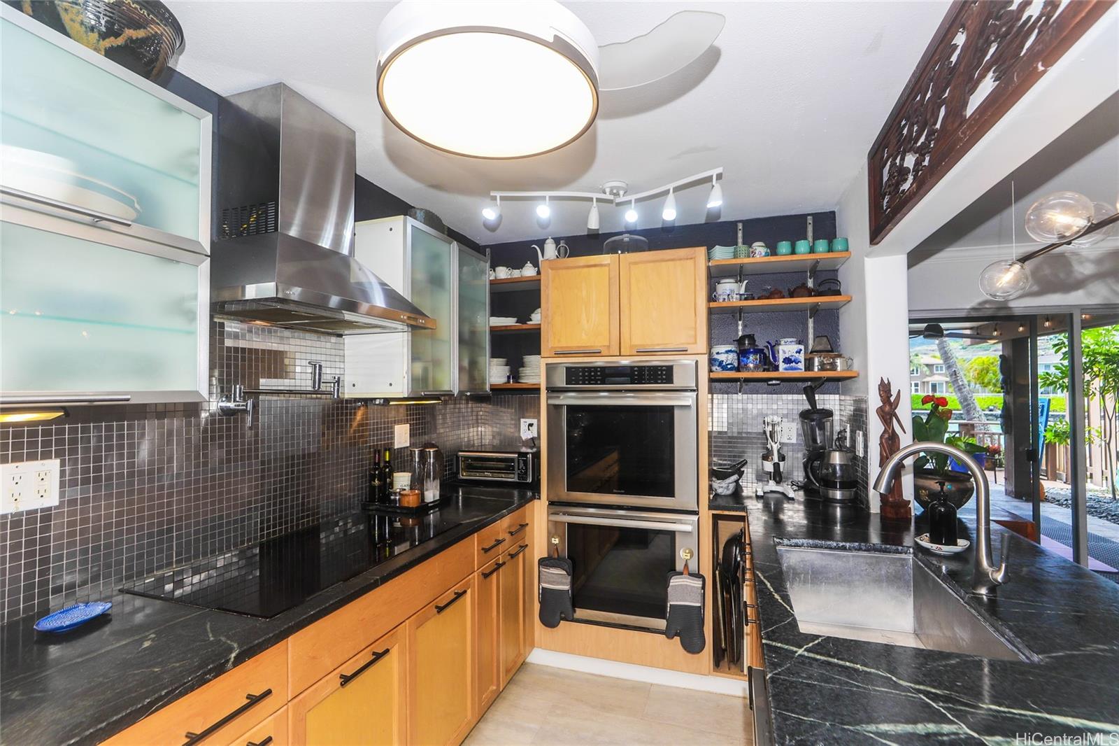 444 Lunalilo Home Road, Unit 312 Honolulu, HI 96825 - Photo 12 of 25 a kitchen with stainless steel appliances granite countertop a stove a sink and a refrigerator