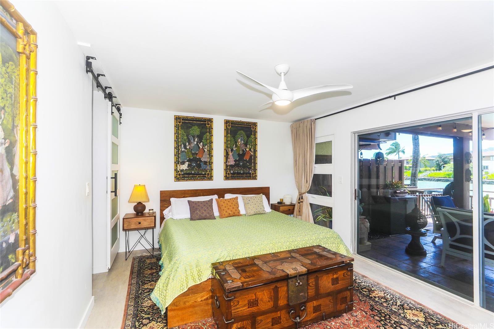 444 Lunalilo Home Road, Unit 312 Honolulu, HI 96825 - Photo 14 of 25 a bedroom with a bed and wooden floor