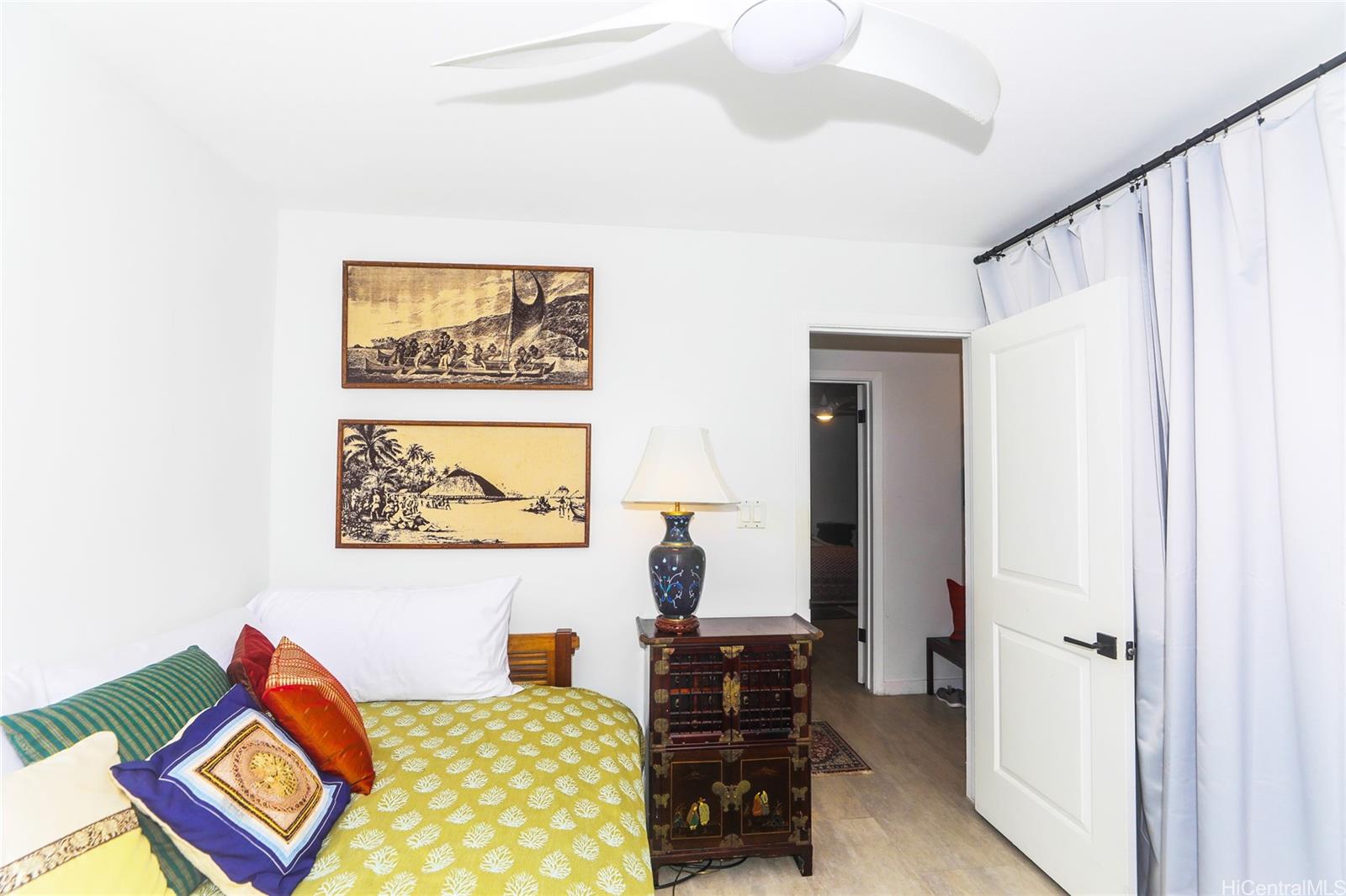 444 Lunalilo Home Road, Unit 312 Honolulu, HI 96825 - Photo 19 of 25 a bedroom with a bed and a lamp on dresser