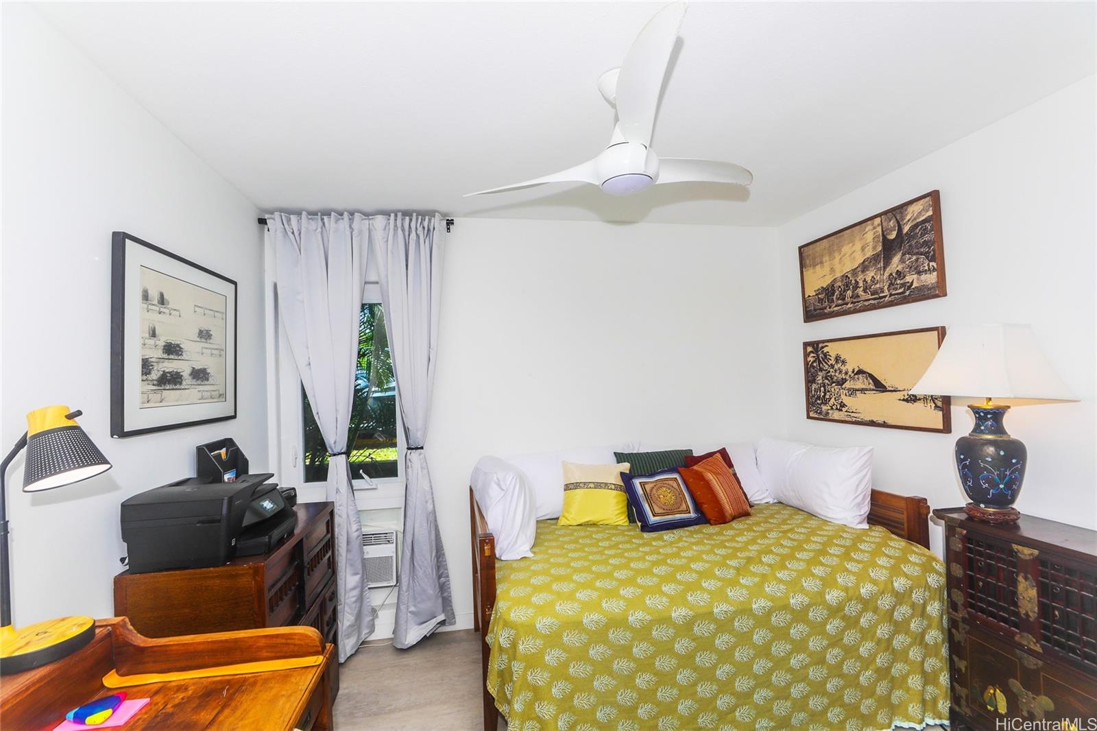 444 Lunalilo Home Road, Unit 312 Honolulu, HI 96825 - Photo 20 of 25 a bedroom with a bed and wooden floor