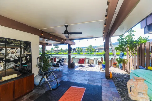 a room with stainless steel appliances kitchen island a table and chairs in it
