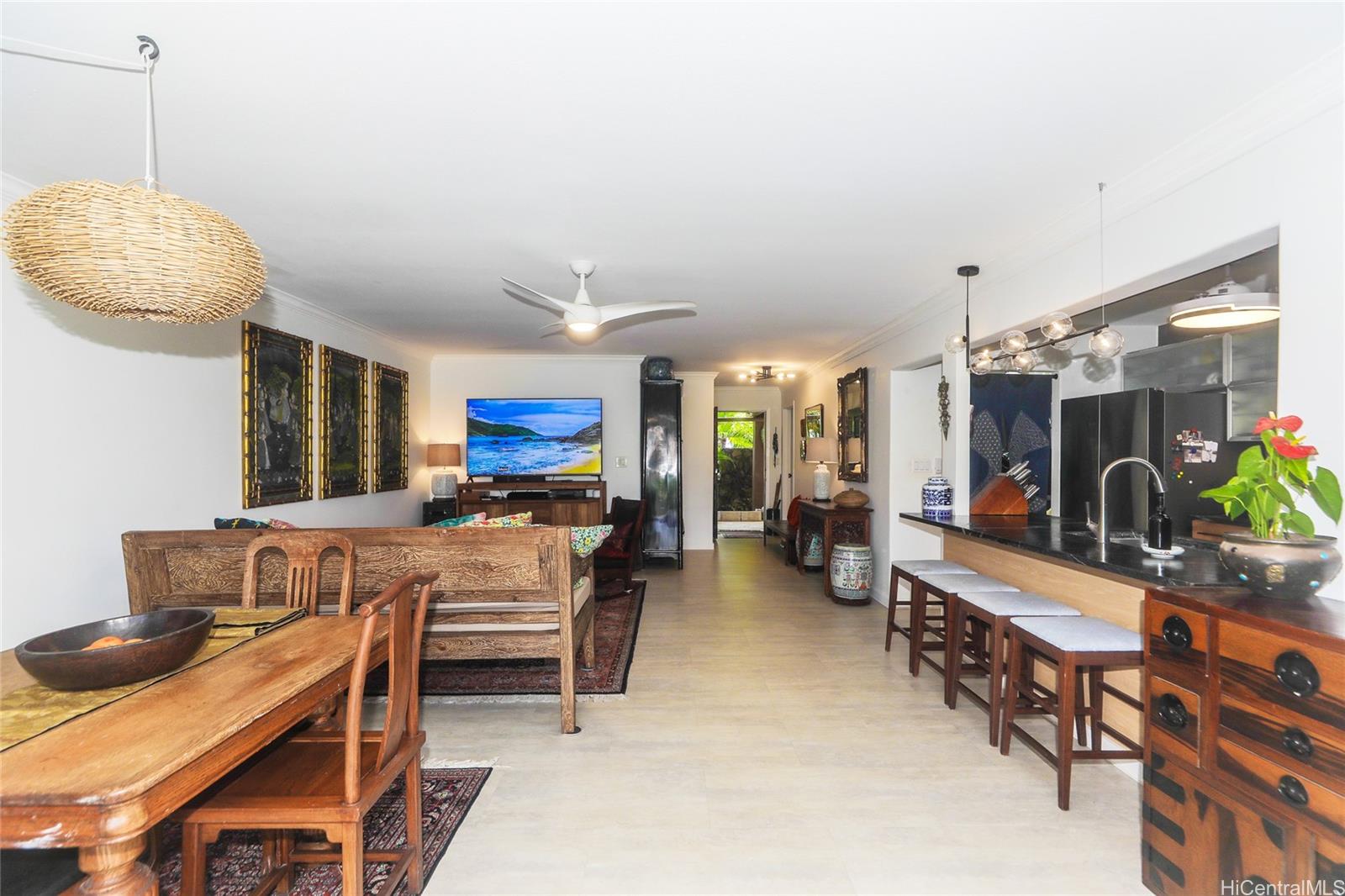 444 Lunalilo Home Road, Unit 312 Honolulu, HI 96825 - Photo 9 of 25 a room with stainless steel appliances kitchen island a table and chairs in it