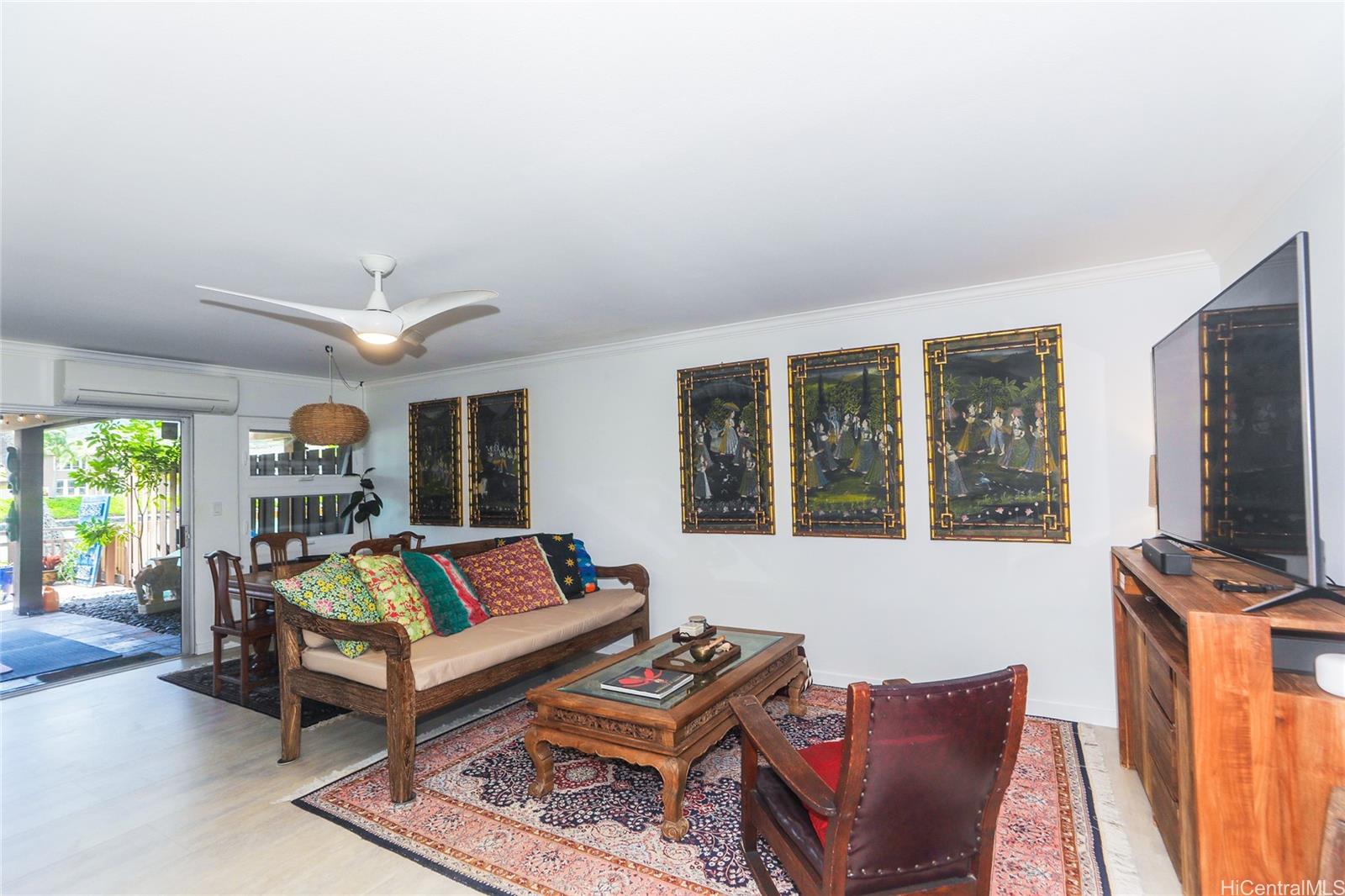 444 Lunalilo Home Road, Unit 312 Honolulu, HI 96825 - Photo 10 of 25 a living room with furniture a flat screen tv and a window