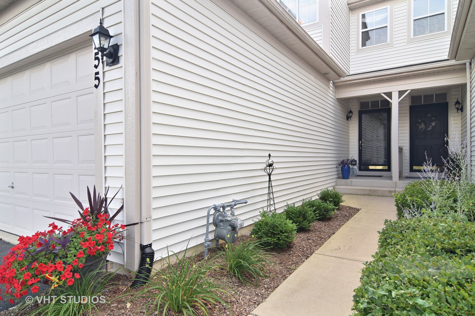 255 Grand Ridge Road St. Charles, IL 60175 - Photo 3 of 14 a potted plant sitting in front of a house