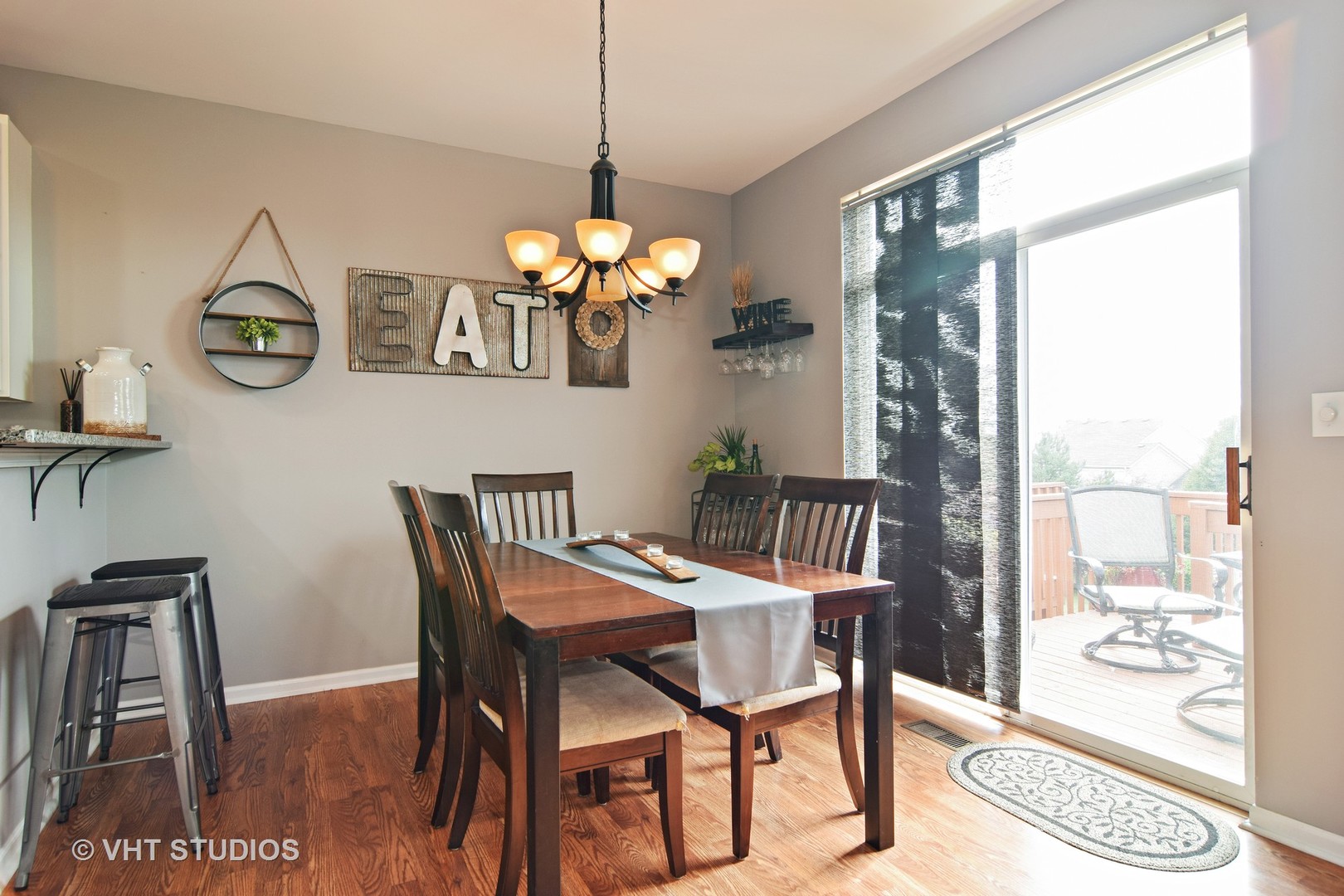 255 Grand Ridge Road St. Charles, IL 60175 - Photo 7 of 14 a view of a dining room with furniture a chandelier and wooden floor
