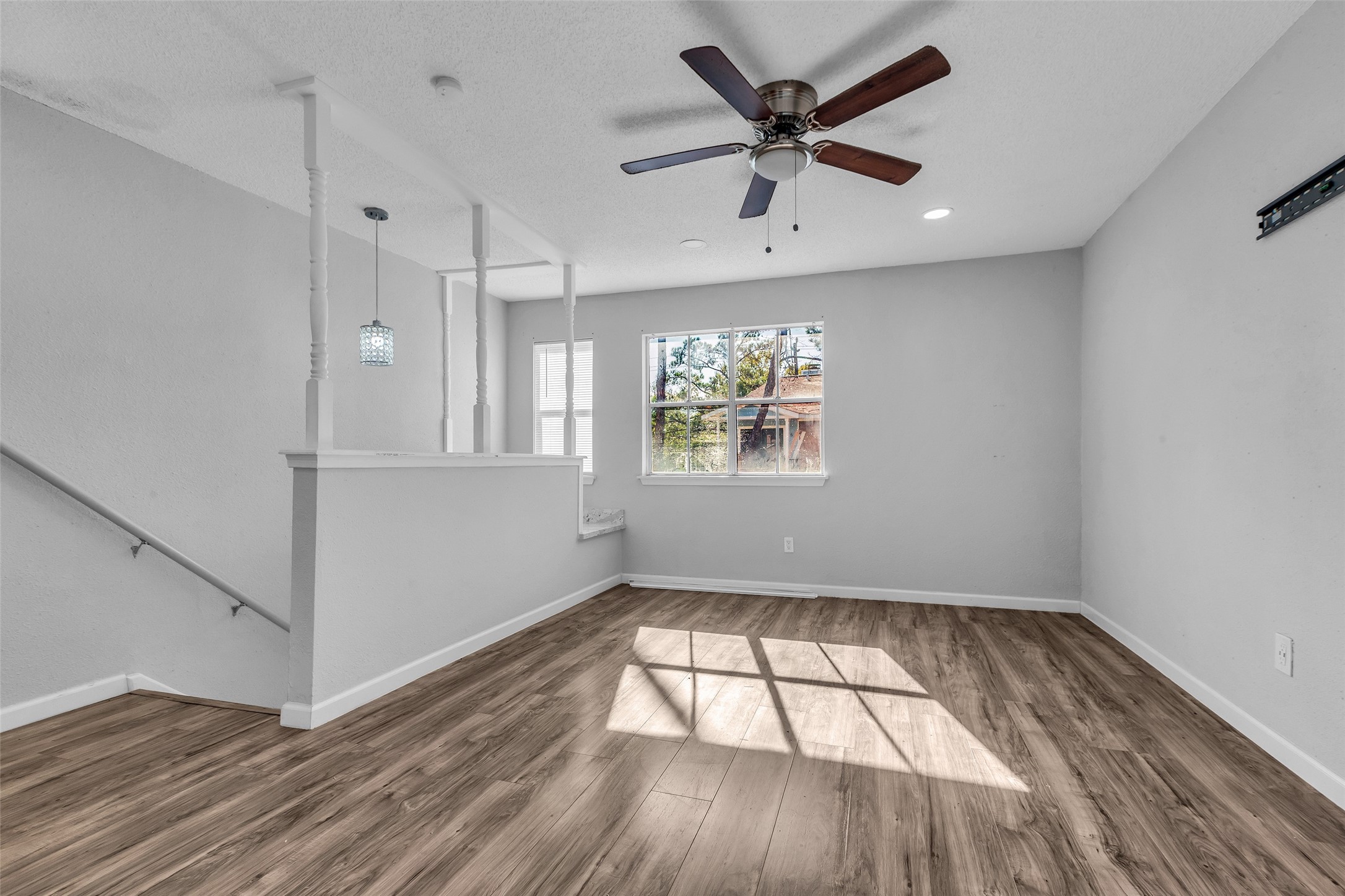 7402 Alabonson Road, Unit 301 Houston, TX 77088 - Photo 7 of 9 wooden floor in an empty room with a window