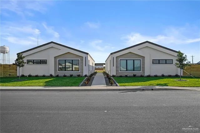 a view of house with outdoor space and tub