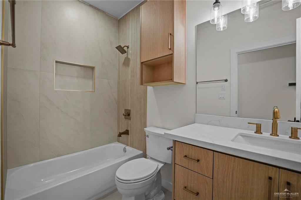 2709 Mockingbird Road, Unit 2 Weslaco, TX 78596 - Photo 12 of 20 a bathroom with a sink a toilet and shower