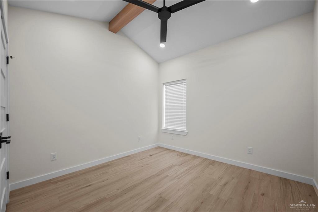 2709 Mockingbird Road, Unit 2 Weslaco, TX 78596 - Photo 17 of 20 an empty room with wooden floor and ceiling fan