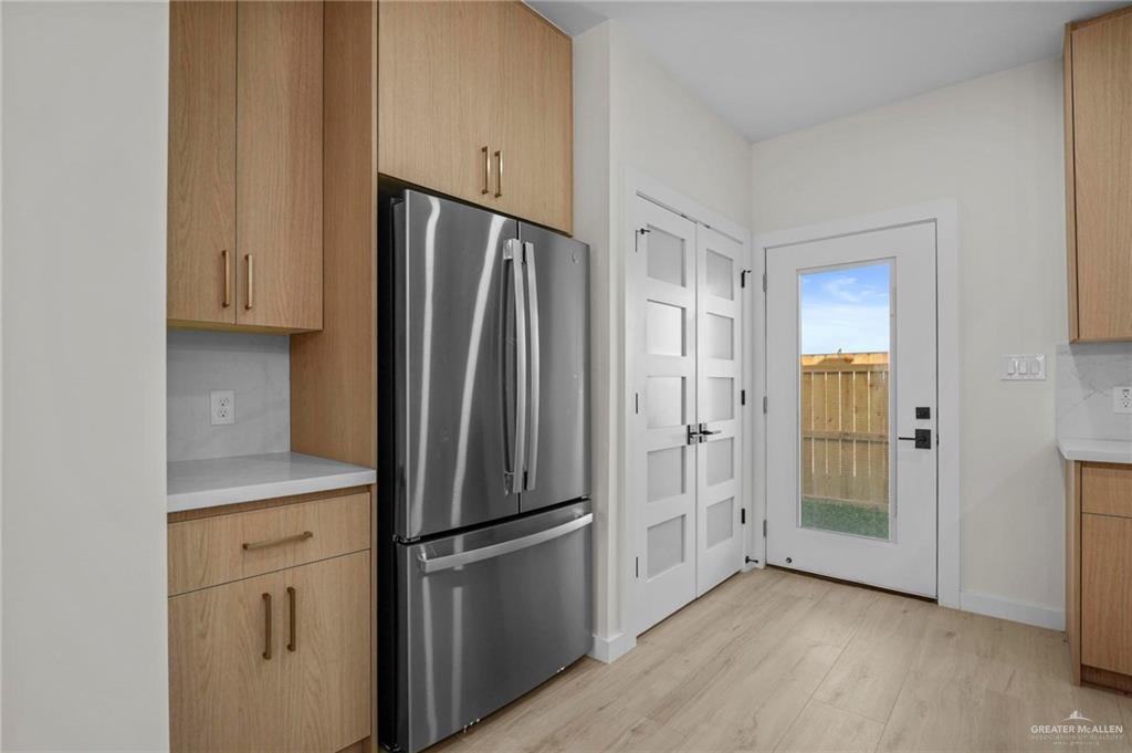 2709 Mockingbird Road, Unit 2 Weslaco, TX 78596 - Photo 8 of 20 a kitchen with stainless steel appliances a refrigerator and cabinets