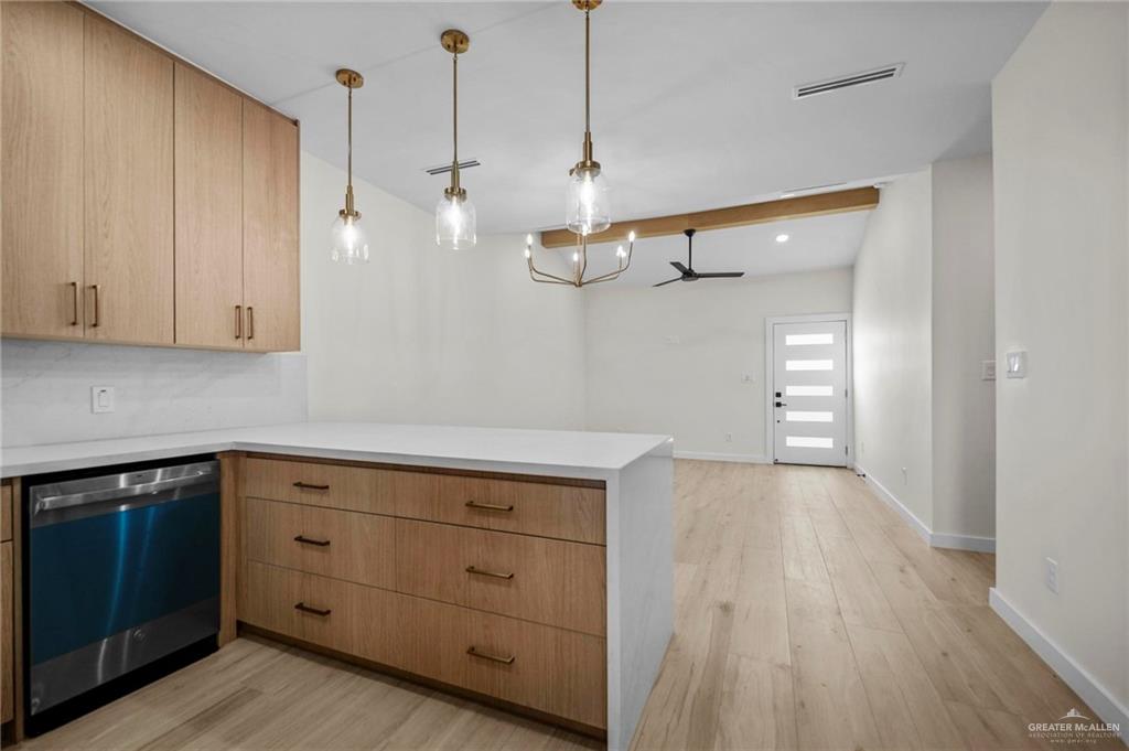 2709 Mockingbird Road, Unit 2 Weslaco, TX 78596 - Photo 9 of 20 a kitchen with a white cabinets and wooden floor