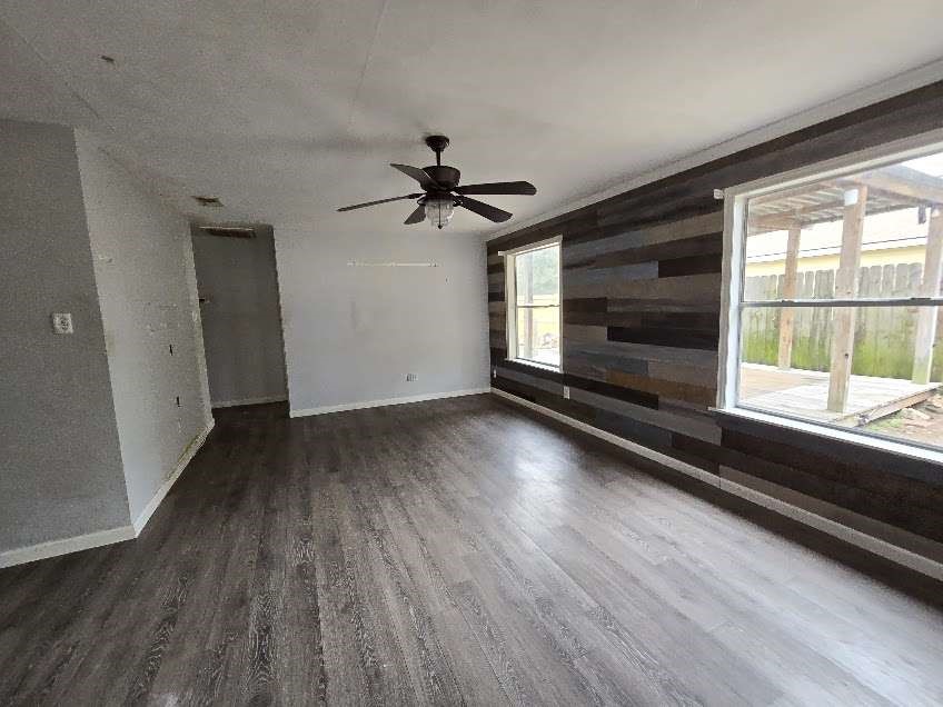 1110 Greencroft Street Channelview, TX 77530 - Photo 2 of 5 wooden floor in an empty room with a window