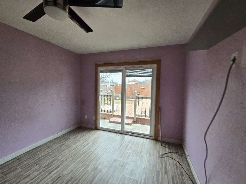 1110 Greencroft Street Channelview, TX 77530 - Photo 4 of 5 an empty room with wooden floor and windows