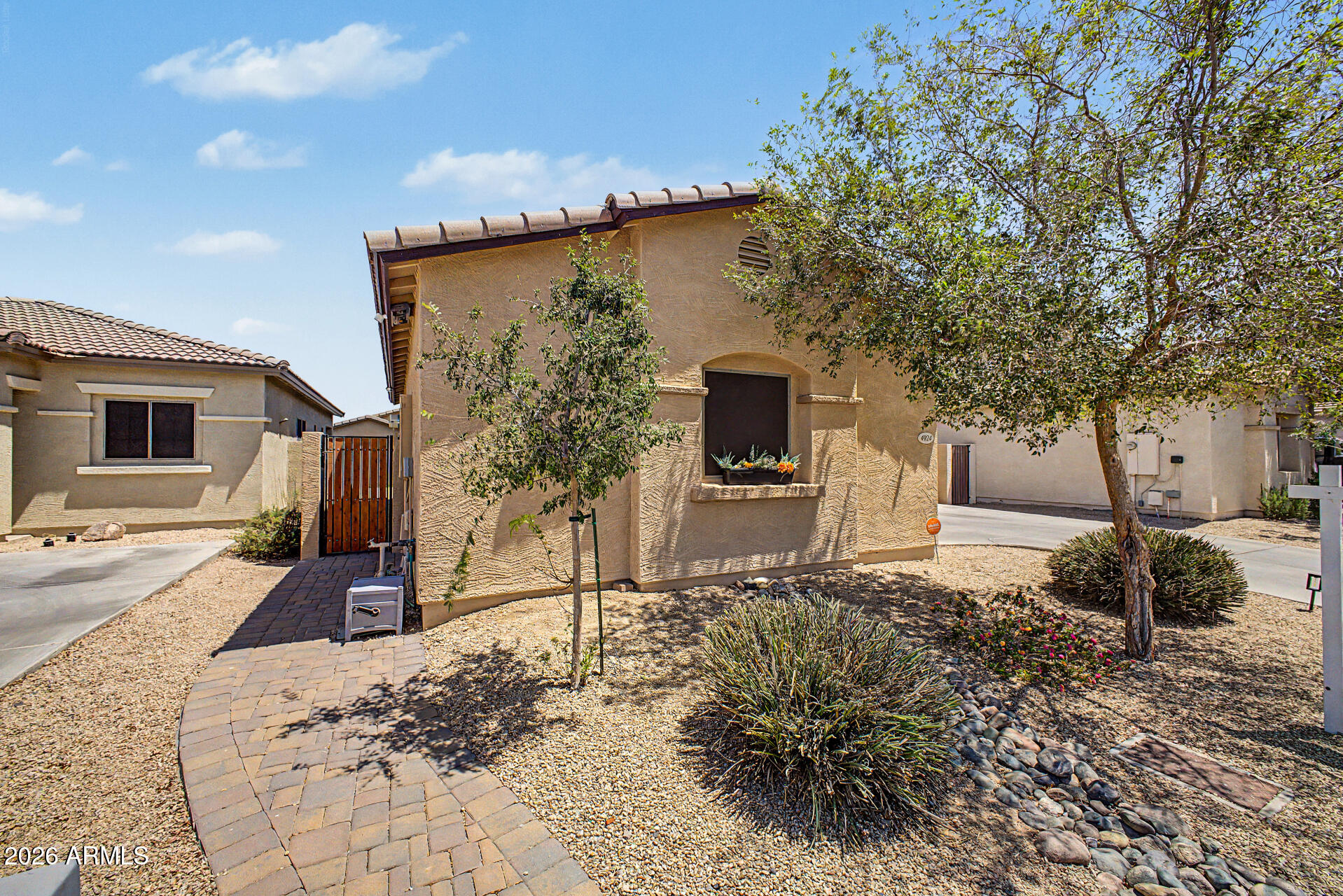 4924 West Harwell Road Laveen, AZ 85339 - Photo 2 of 27 a front view of a house with garden
