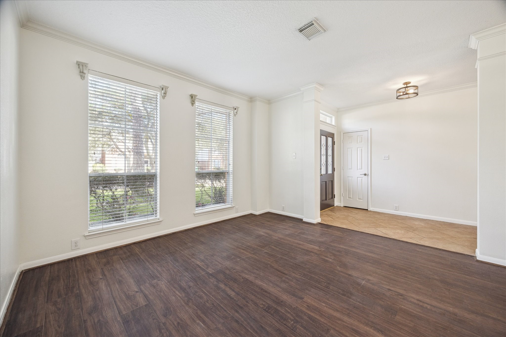 12831 Dove Point Lane Houston, TX 77041 - Photo 9 of 50 a view of an empty room with wooden floor and a window