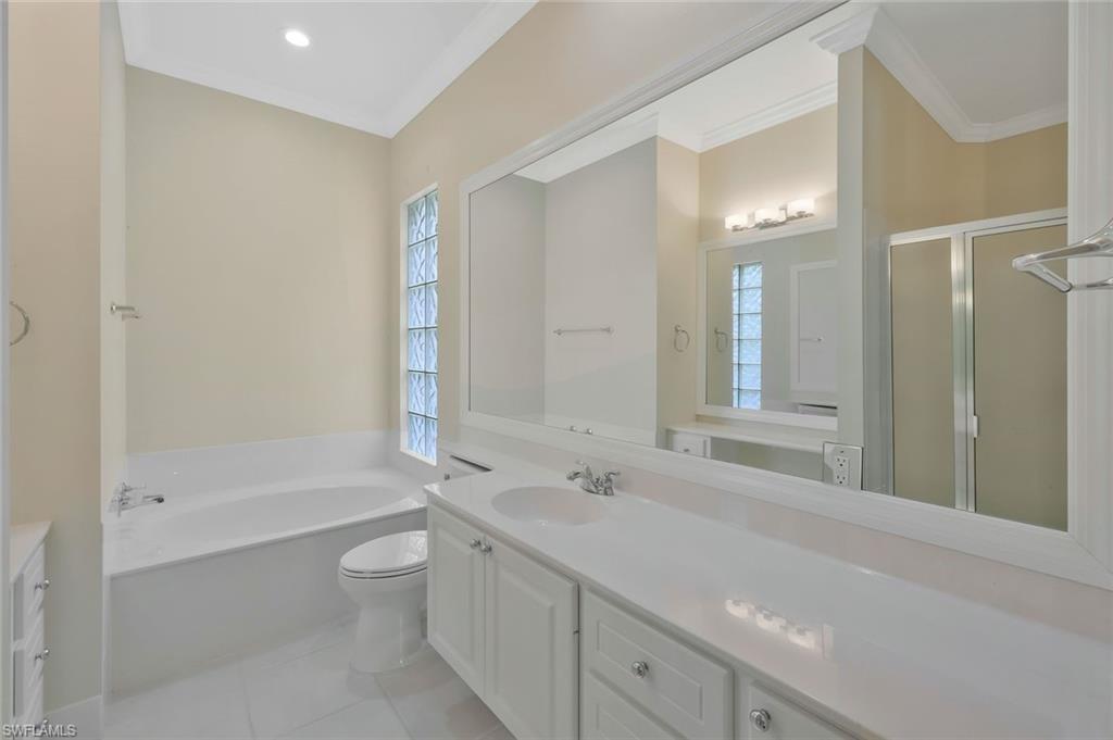 6044 Andros Way Naples, FL 34119 - Photo 15 of 46 Full bathroom with vanity, crown molding, and a bath