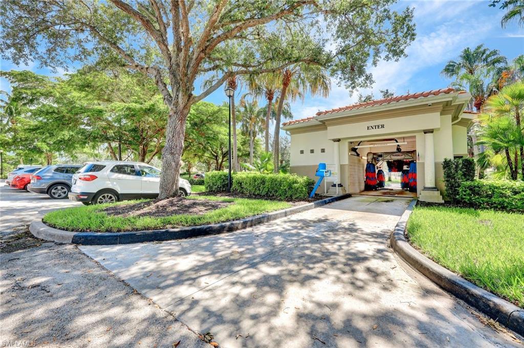 6044 Andros Way Naples, FL 34119 - Photo 41 of 46 View of front of home featuring a tile roof, a garage, driveway, and stucco siding