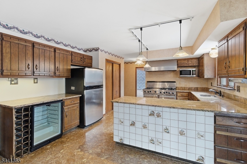439 Long Hill Road Hillsborough, NJ 08844 - Photo 16 of 41 a kitchen with stainless steel appliances granite countertop a sink a stove and a refrigerator