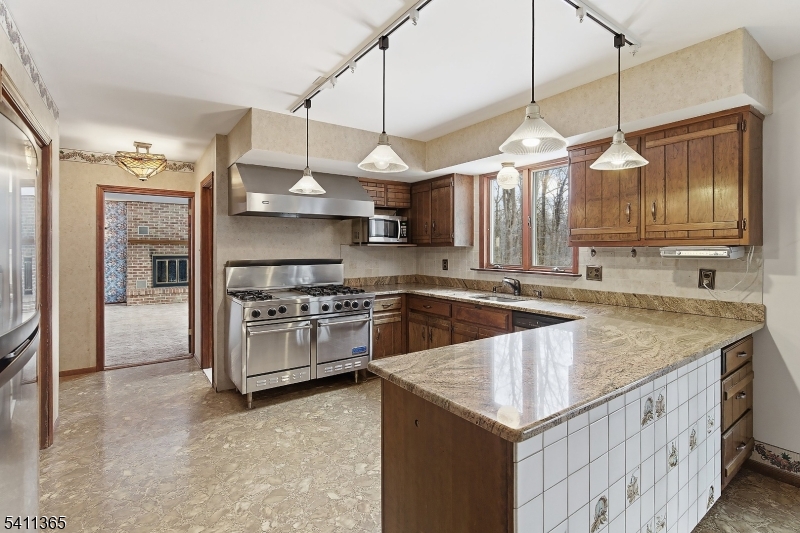 439 Long Hill Road Hillsborough, NJ 08844 - Photo 17 of 41 a kitchen with stainless steel appliances granite countertop a sink a stove and a refrigerator