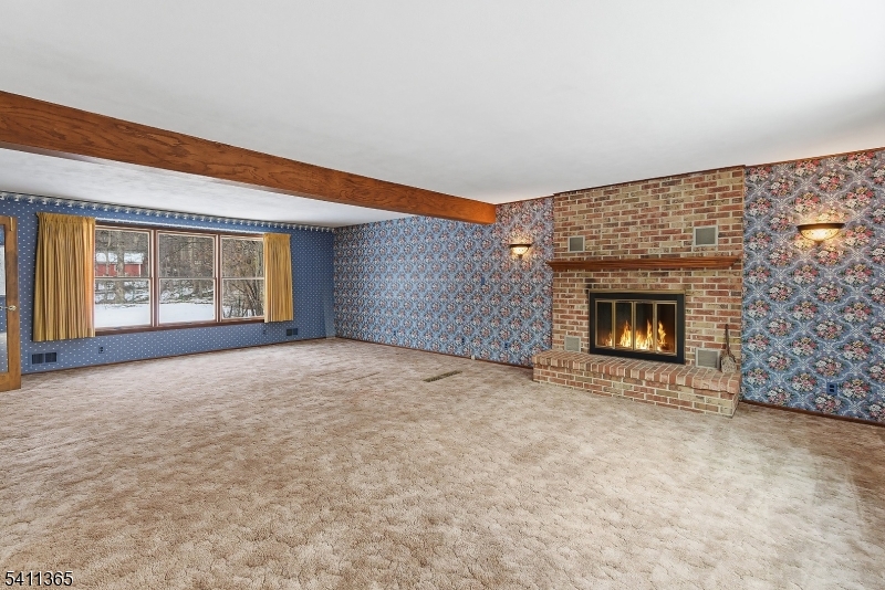 439 Long Hill Road Hillsborough, NJ 08844 - Photo 18 of 41 an empty room with a fireplace and fan