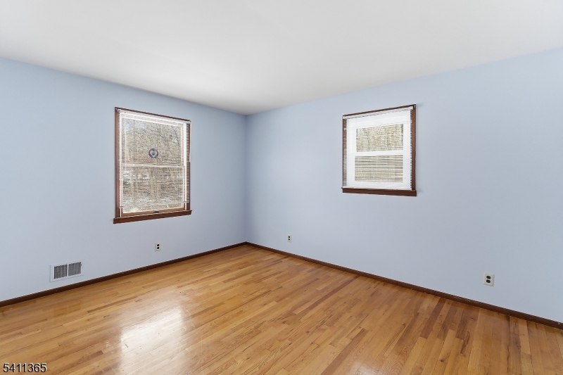 439 Long Hill Road Hillsborough, NJ 08844 - Photo 23 of 41 a view of an empty room with wooden floor and a window