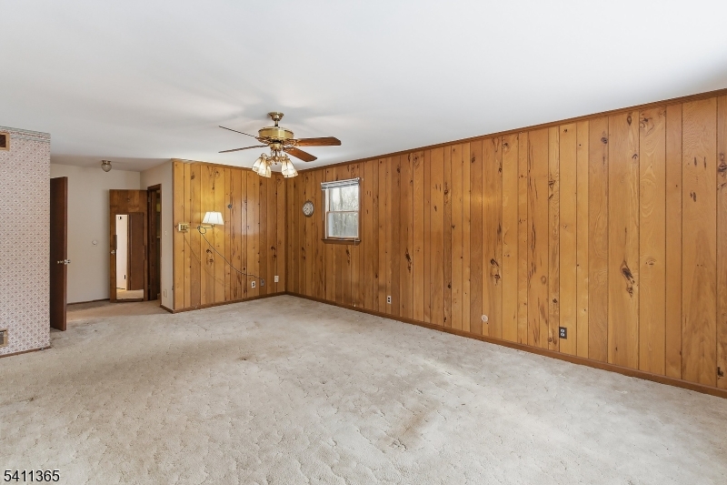 439 Long Hill Road Hillsborough, NJ 08844 - Photo 28 of 41 an empty room with a chandelier fan and windows