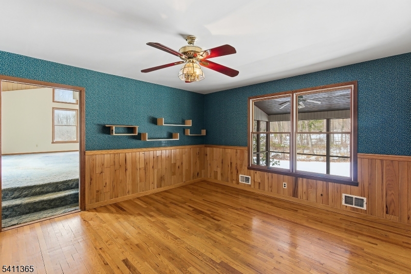 439 Long Hill Road Hillsborough, NJ 08844 - Photo 9 of 41 a view of an empty room with window and wooden floor