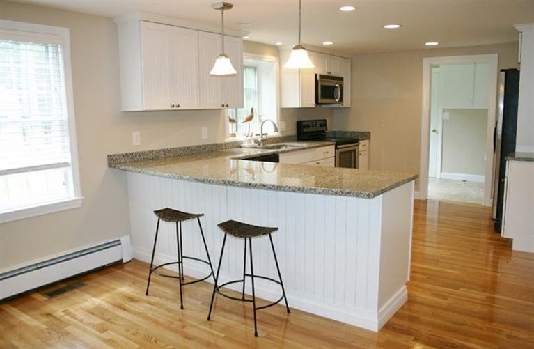 85 Holly Hill Road Centerville, MA 02632 - Photo 7 of 35 a kitchen with kitchen island granite countertop a sink a counter top space appliances and cabinets