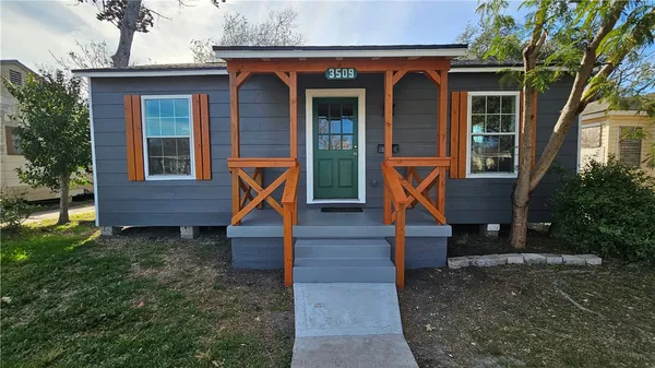 a view of front door of house with a yard