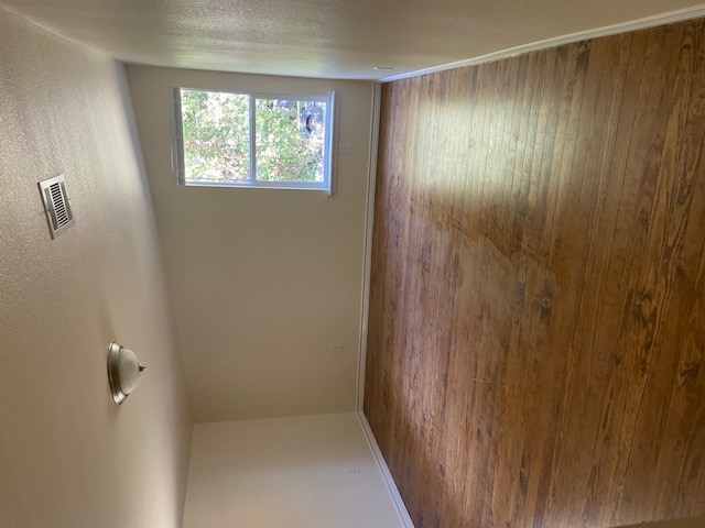 823 Monterrey Street Lockhart, TX 78644 - Photo 12 of 14 a view of an empty room with wooden floor and a window