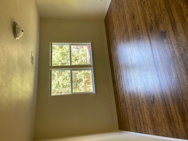 823 Monterrey Street Lockhart, TX 78644 - Photo 13 of 14 an empty room with wooden floor and windows