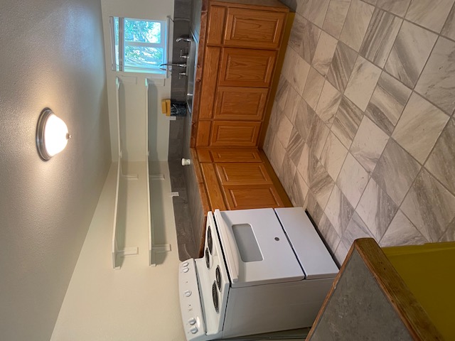 823 Monterrey Street Lockhart, TX 78644 - Photo 5 of 14 a kitchen with stainless steel appliances granite countertop a sink and cabinets