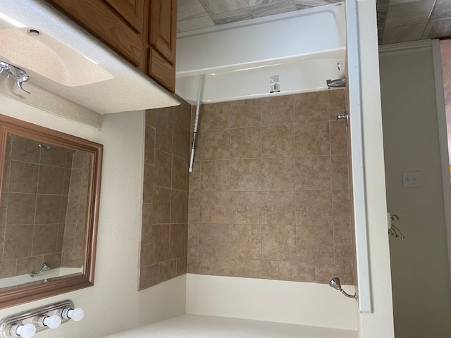 823 Monterrey Street Lockhart, TX 78644 - Photo 9 of 14 a bathroom with a sink and a bathtub