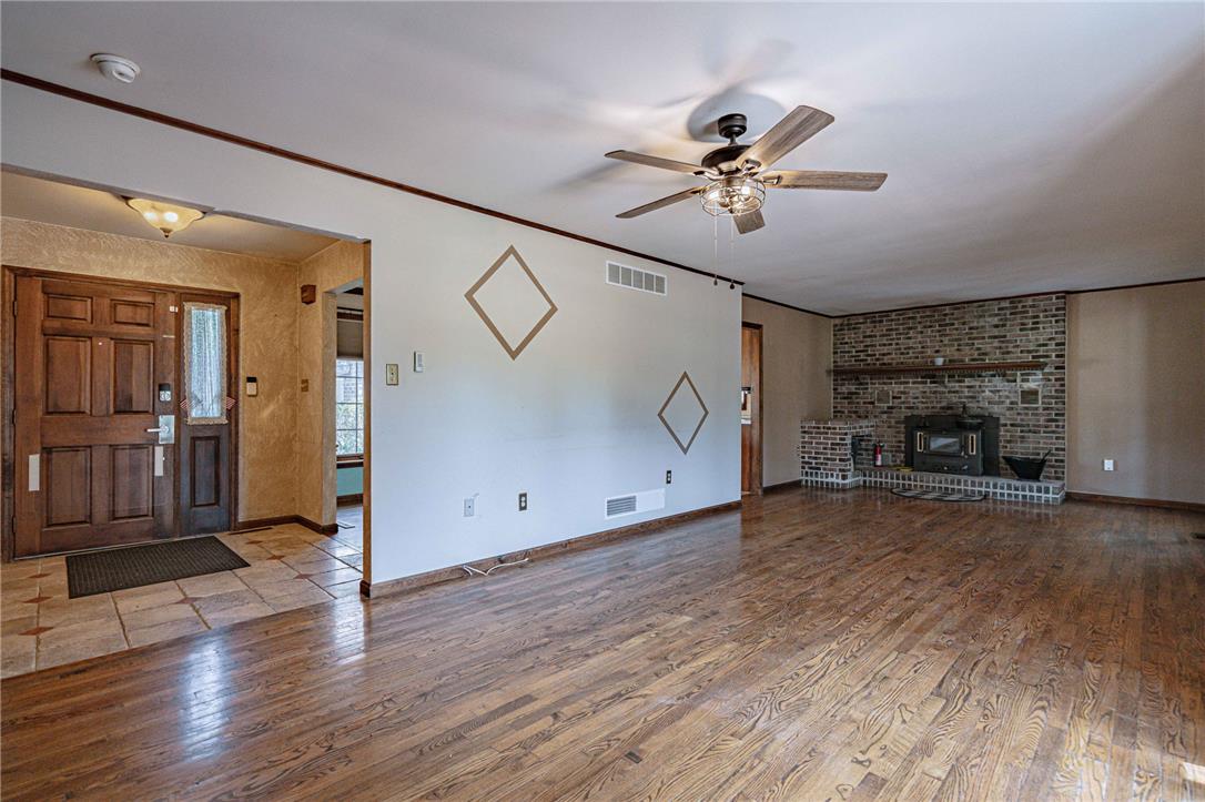 652 Old State Road Oley, PA 19547 - Photo 22 of 54 Rich hardwood floors flow through this welcoming living space, anchored by a prominent brick fireplace.
