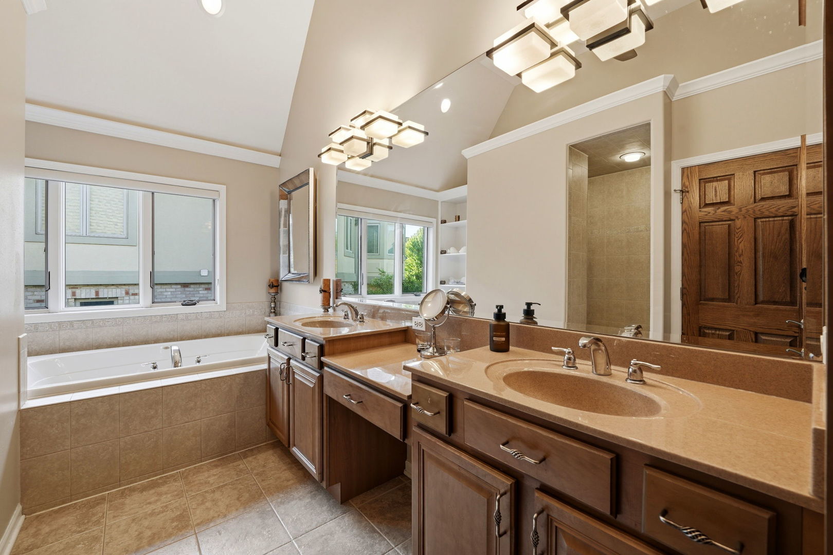 1406 Rue Paris Place Inverness, IL 60067 - Photo 24 of 35 a bathroom with a tub a double vanity sink a large mirror and a bathtub