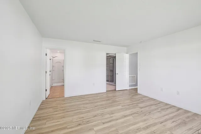 a view of an empty room and a window