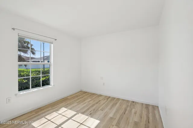 a view of an empty room and wooden floor