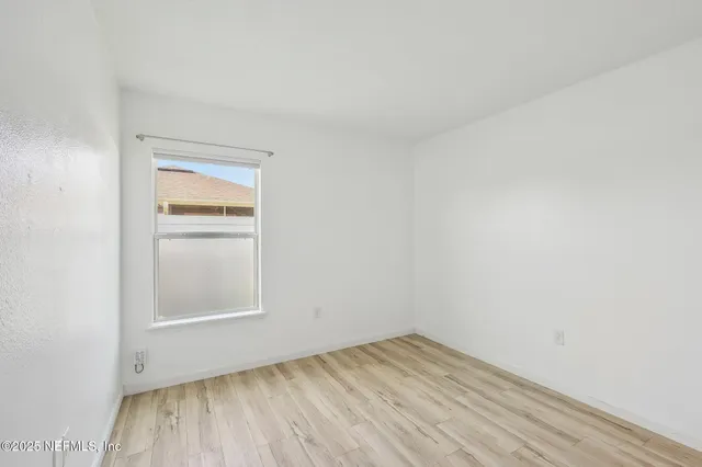 a view of a room with wooden floor