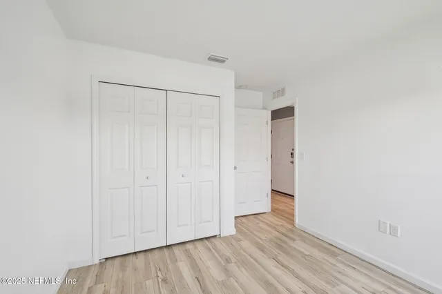 a bathroom with a granite countertop toilet and a sink