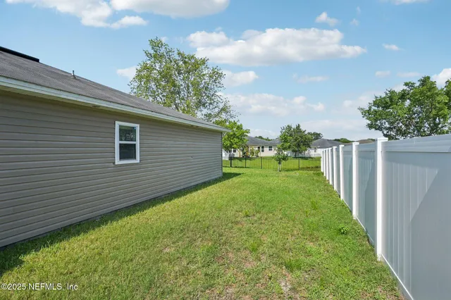 a house with huge green field in front of it