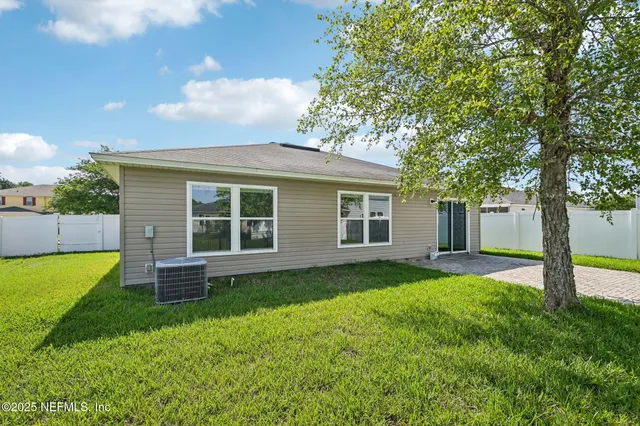 a house with green field in front of it