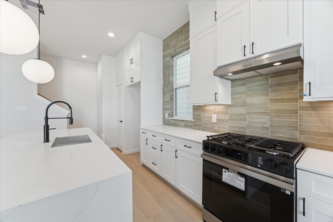 817 Thornton Road, Unit F Houston, TX 77018 - Photo 17 of 36 a kitchen that has a stove and a sink