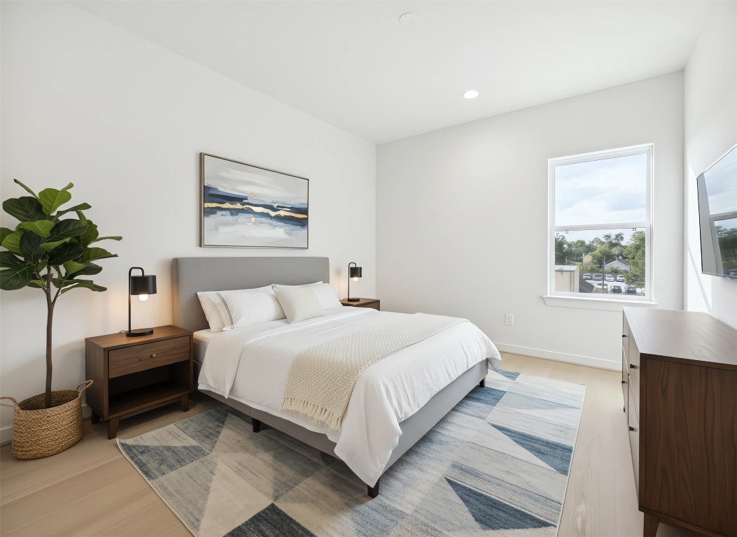 817 Thornton Road, Unit F Houston, TX 77018 - Photo 25 of 36 a bedroom with bed and a potted plant