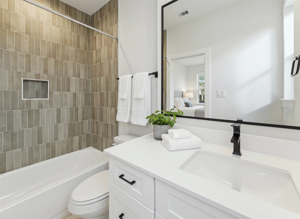 817 Thornton Road, Unit F Houston, TX 77018 - Photo 8 of 36 a bathroom with a granite countertop sink a toilet and shower