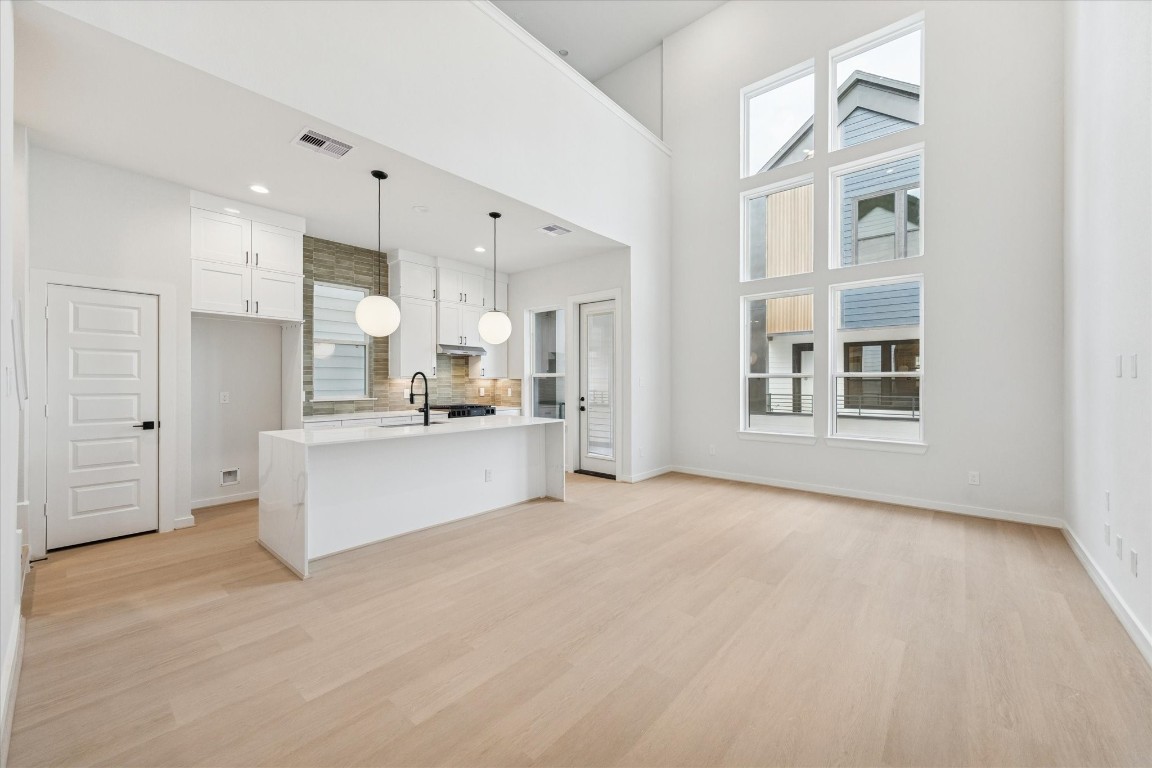 817 Thornton Road, Unit F Houston, TX 77018 - Photo 9 of 36 a view of kitchen with stainless steel appliances kitchen island a refrigerator oven a white stove with white cabinets