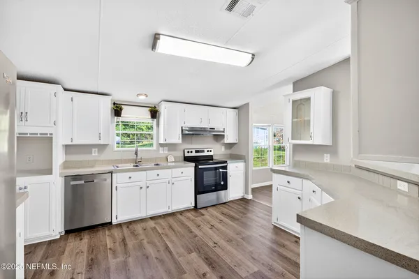 a large kitchen with a stove top oven