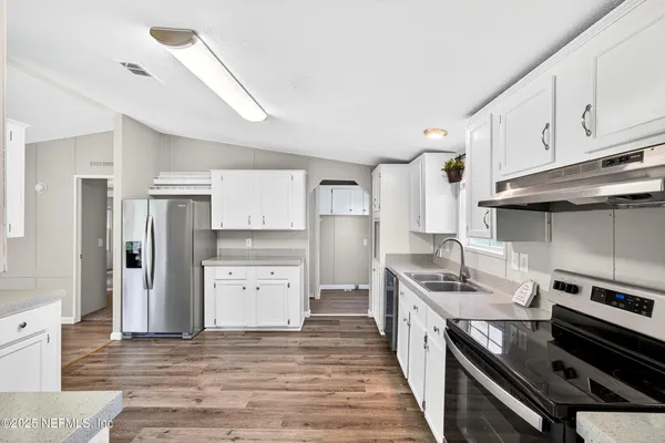a kitchen with a stove and a refrigerator