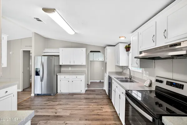 a kitchen with a stove and a refrigerator